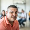 Portrait of mid adult man during a group therapy at mental health center